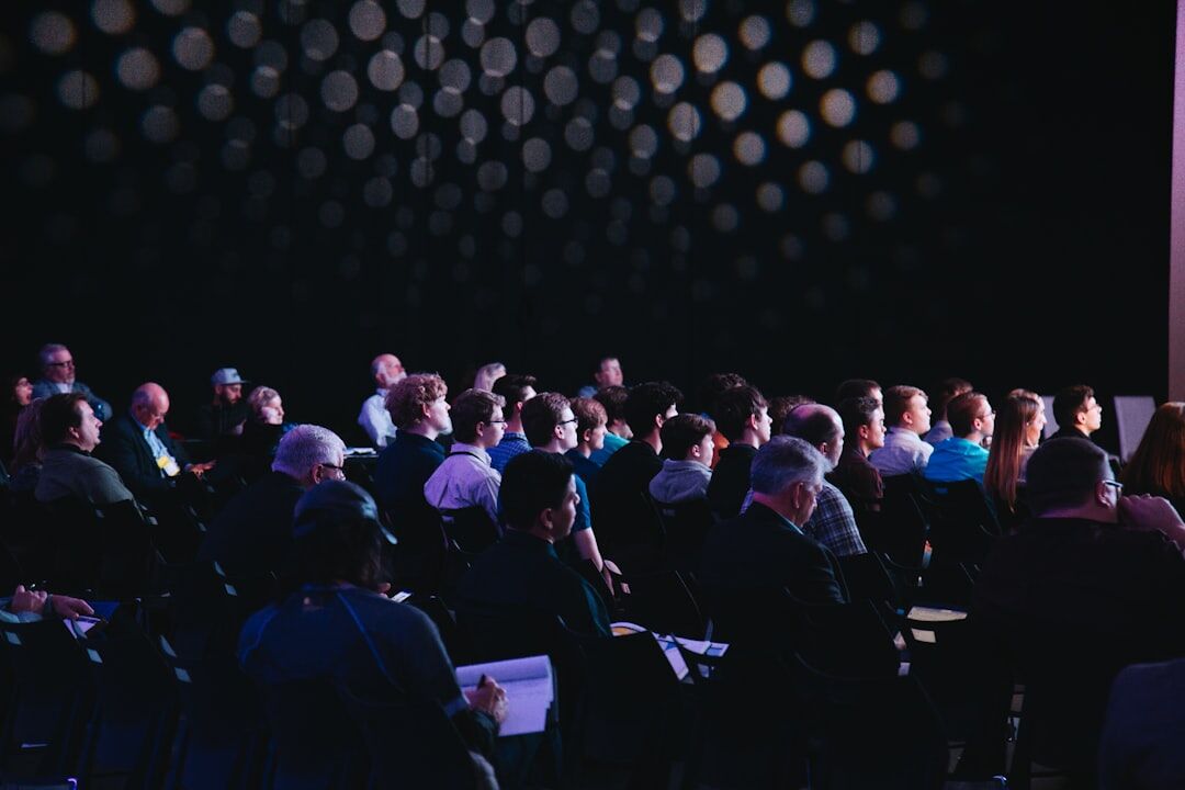 Technology conference with speaker presenting on stage to an audience