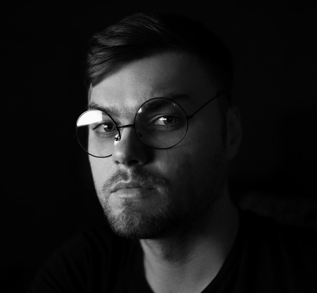 Professional portrait of a Turkish man with glasses and stubble in business casual attire