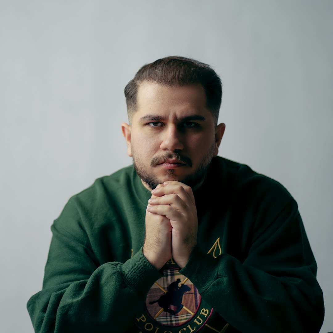 Professional portrait of a Turkish man in his 30s with a beard in a formal setting